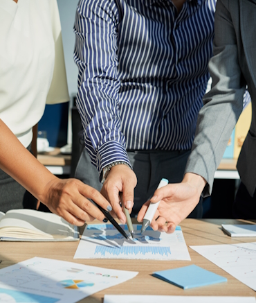 Cropped image of business executives analyzing financial statistics